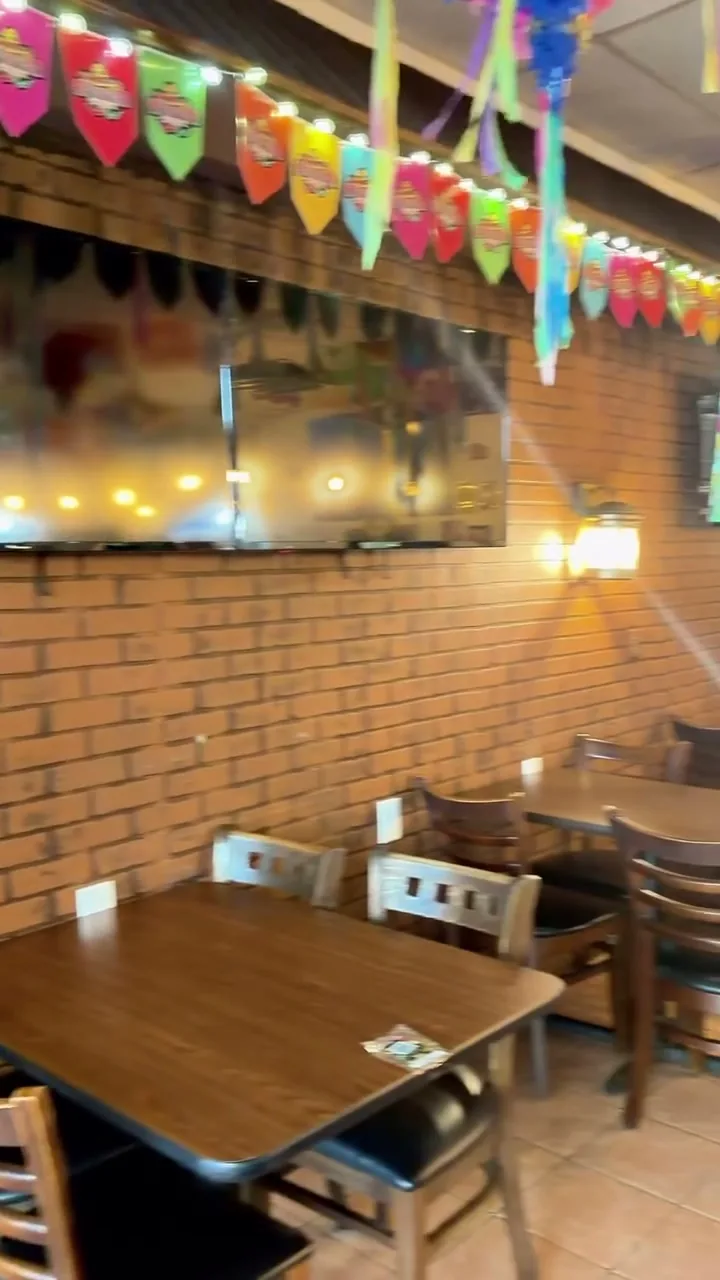 The Autentica Taqueria dining room in Kendall with papel picado banners overhead