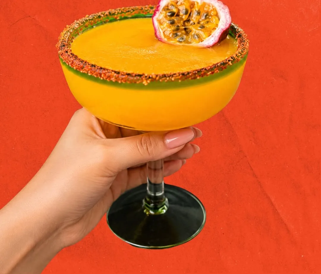 The Golden Passionrita, a frozen passionfruit margarita with a chile salt rim, served at Autentica Taqueria in Kendall, Miami
