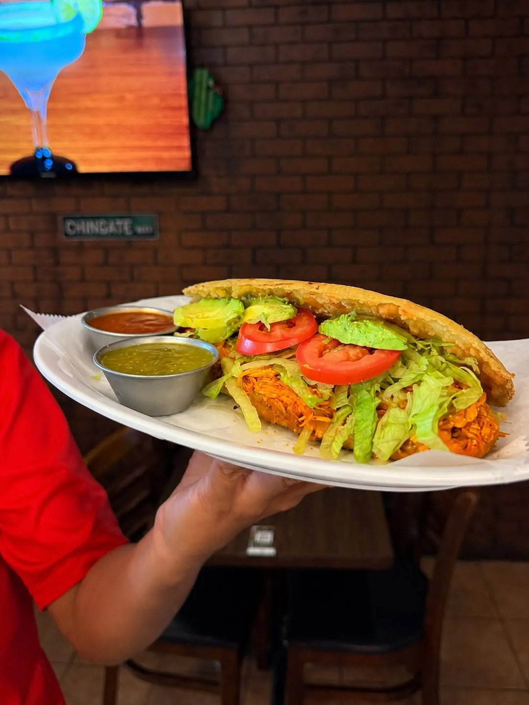 A huarache plate carried out of the kitchen at Autentica Taqueria