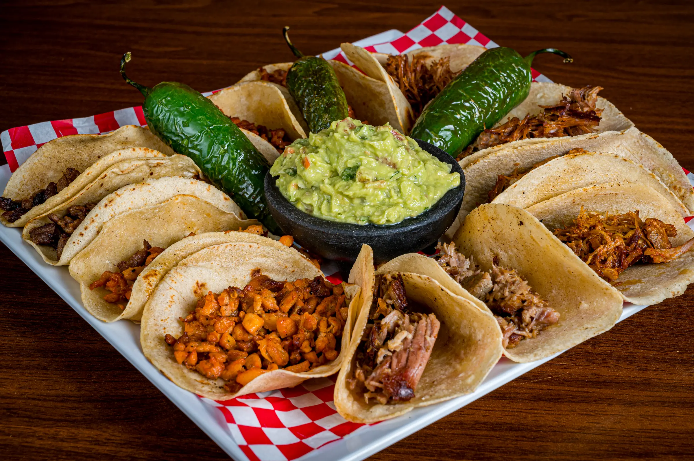 Autentico Taco Sampler, twelve street tacos on handmade corn tortillas with guacamole and roasted jalapenos at Autentica Taqueria in Kendall, Miami